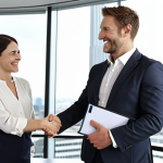 ** A confident financial consultant shaking hands with a client in a modern office setting. The consultant is holding a CFA charter and is smiling.

**